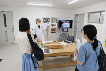 製麹の動画を見ながら、伝統的な酒造りについて説明を受ける参加者